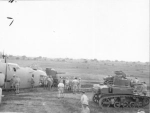 M3 lights tanks in front of a B24 plane