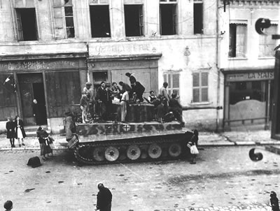 Civilians on top of a neutralized PzKpfw VI Tiger 1 Heavy Tank during the Battle of Normandy