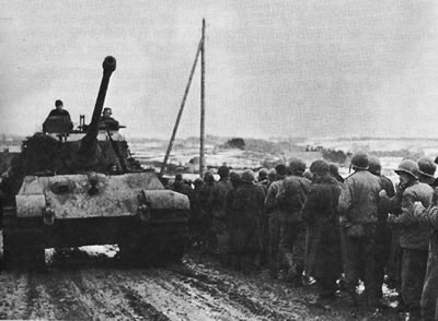 American POWs being herded by a German King Tiger tank at the Battle of the Bulge