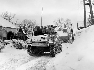 American M4 Sherman tank advancing on Schopen, Belgium during the  Battle of the Bulge